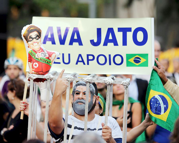 Brazil's Lula sworn in over protests as Rousseff faces impeachment